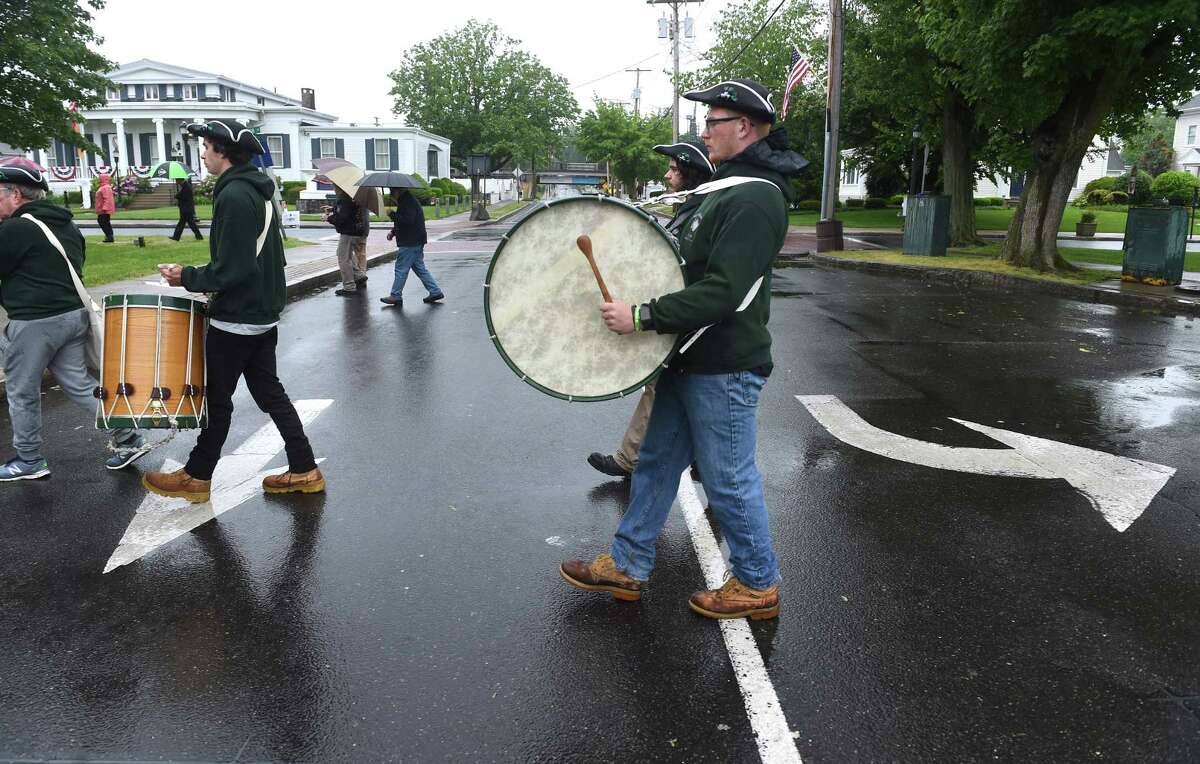 Members of the Milford Volunteers Ancient Fife & Drum Corps cross High Street during a Memorial Day wreath laying ceremony in Milford on May 30, 2021.