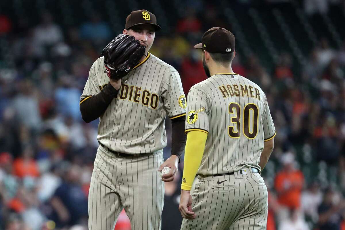 San Diego Padres players talk during a baseball game against the