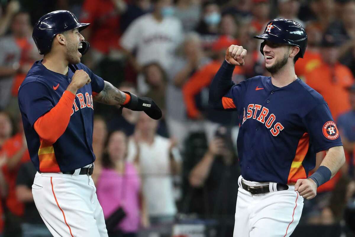 Houston Astros shortstop Carlos Correa, left, greets right fielder Kyle Tucker (30) at home after scoring on Tucker's 3-run home run off San Diego Padres starting pitcher Blake Snell during the first inning of a major league baseball game Sunday, May 30, 2021, at Minute Maid Park in Houston.
