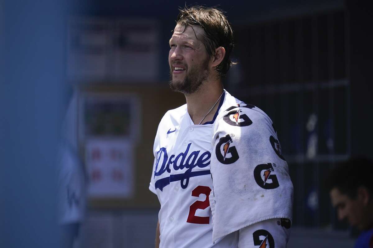 Los Angeles Dodgers starting pitcher Clayton Kershaw (22) ices his left arm in the dugout in the bottom of the first inning of a baseball game against the San Francisco Giants Sunday, May 30, 2021, in Los Angeles. (AP Photo/Ashley Landis)