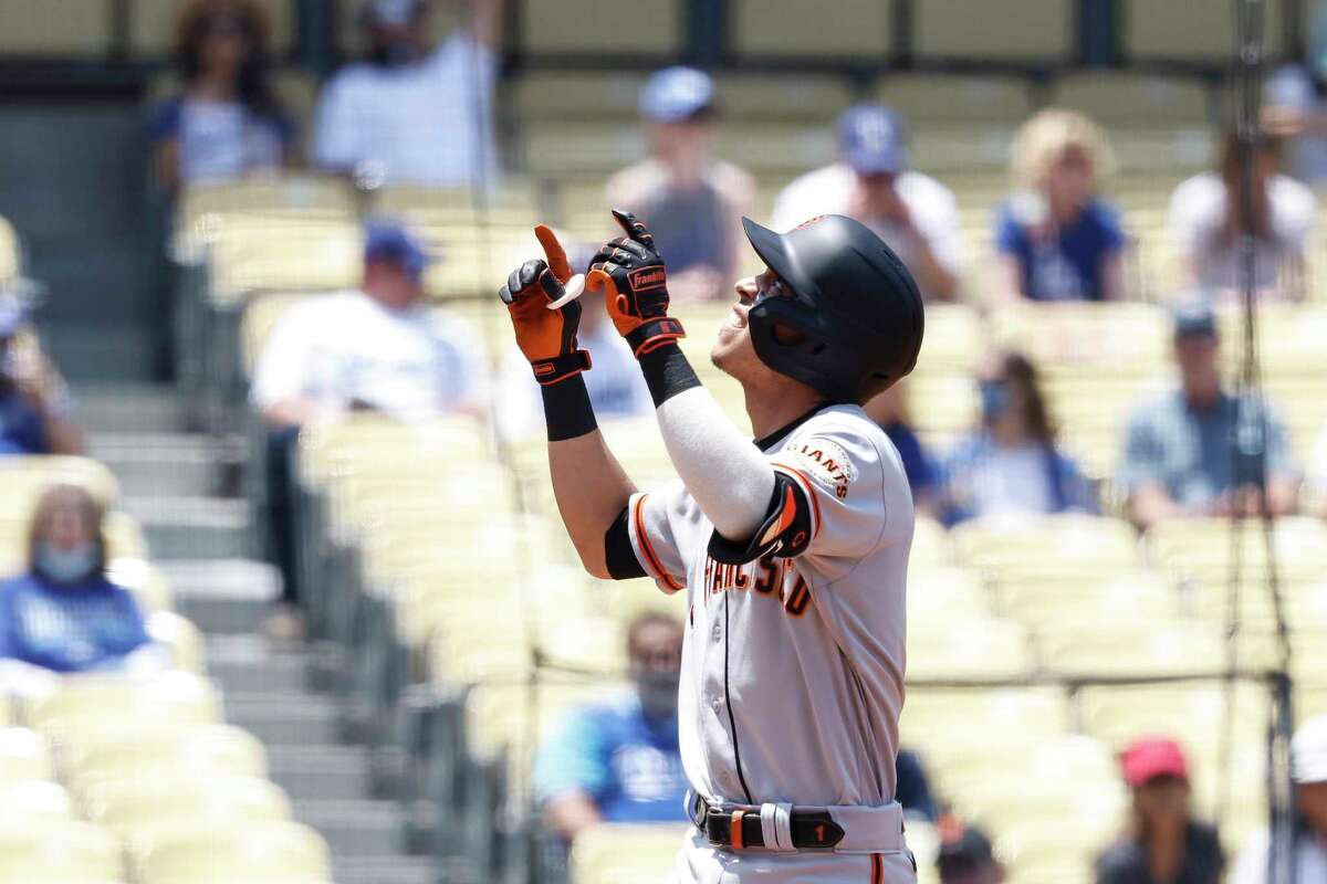 Mauricio Dubon of the San Francisco Giants celebrates after hitting a two-run homer against the Los Angeles Dodgers during the first inning at Dodger Stadium on May 30, 2021 in Los Angeles.