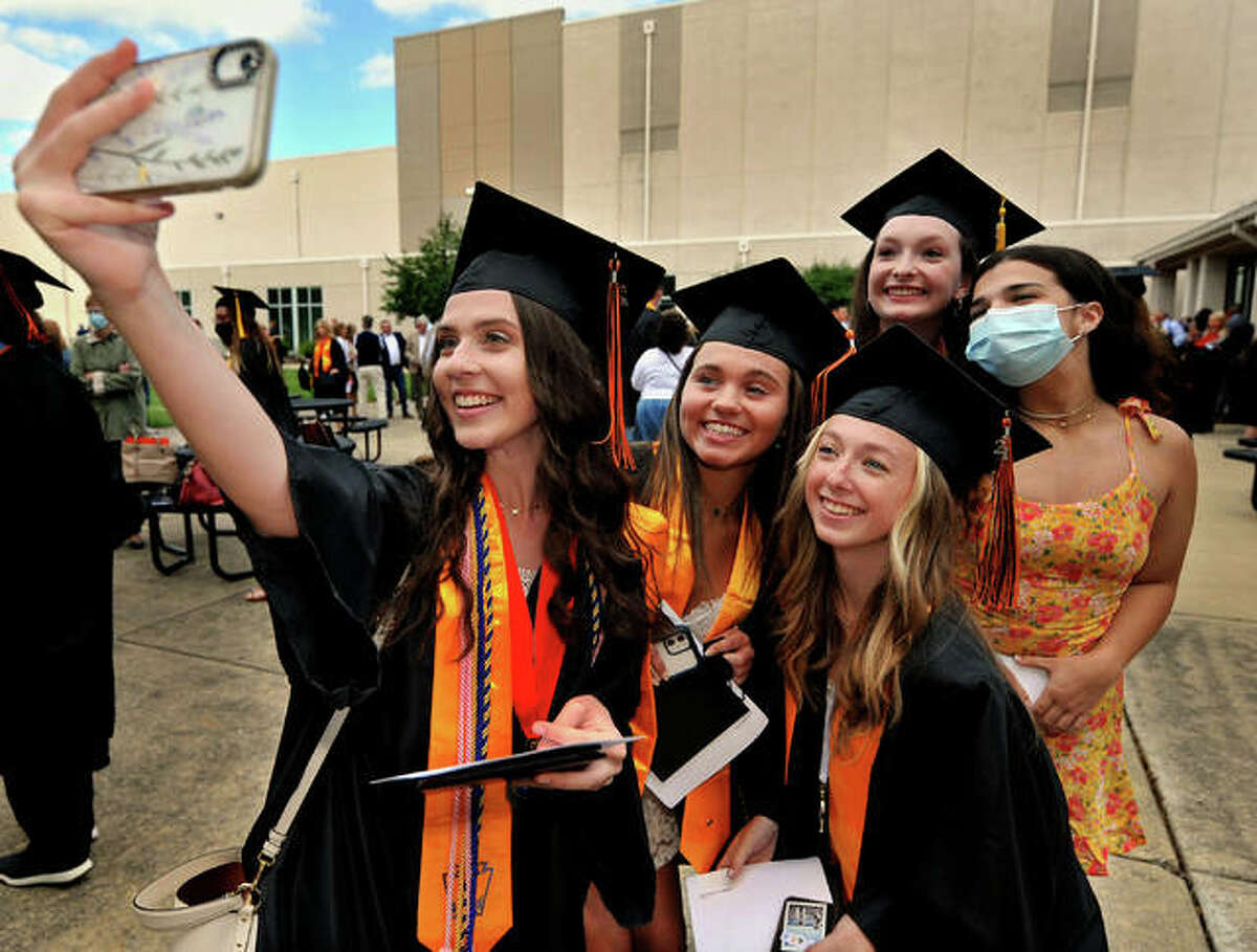 A group of graduates takes a selfie of themselves after the commencement ceremony at a past graduation at Edwardsville High School.