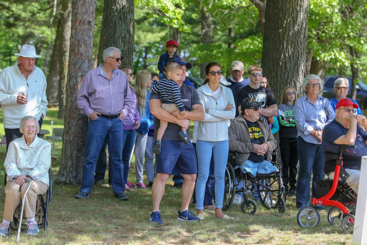 Veterans perform a Memorial Day service at the cemetery in Caseville Monday morning as area residents and visitors look on.