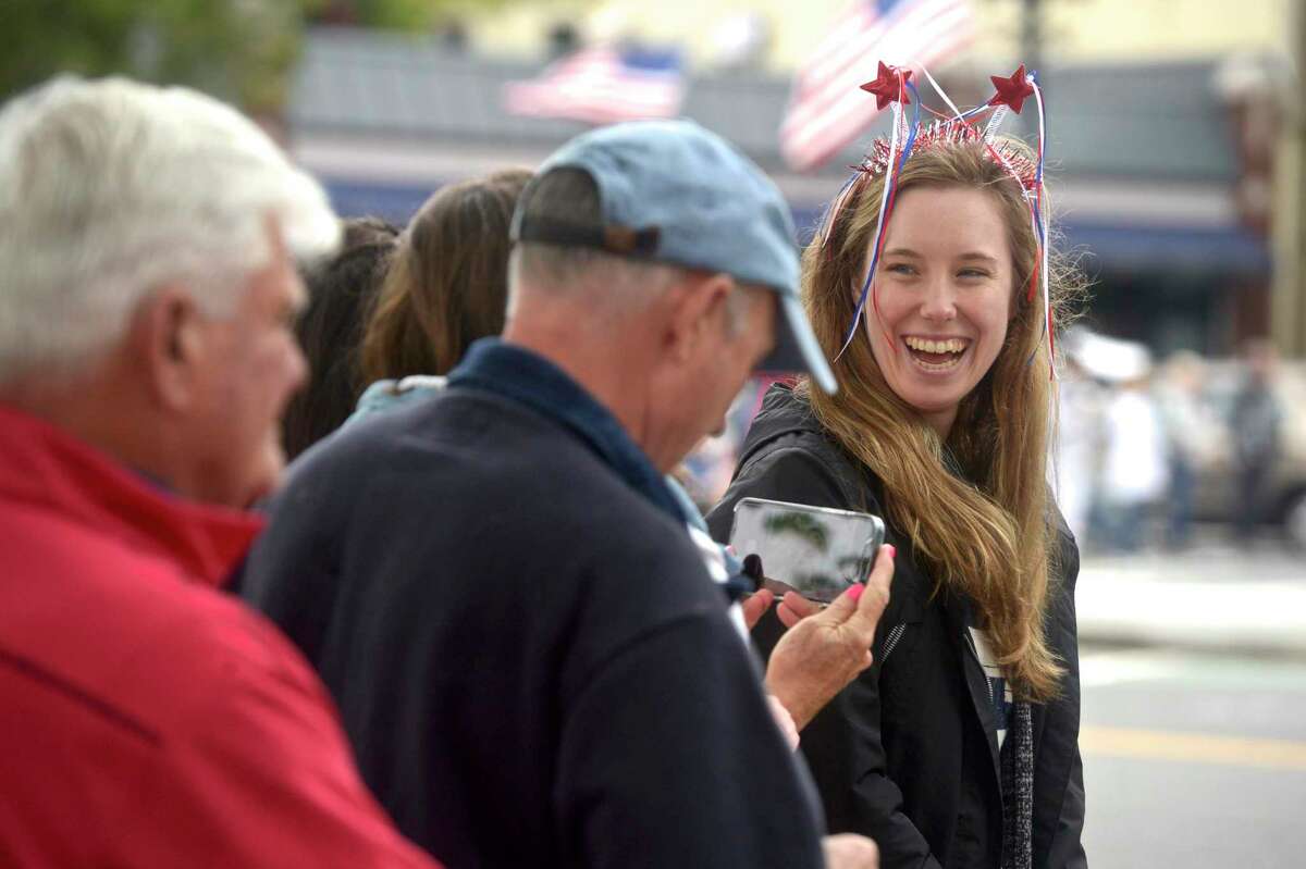 Abigail Forsberg, of Danbury, waits for the Memorial Day parade in New Milford, Conn, to start. She was there to watch her boyfriend march with the Northville Volunteer Fire Department. Monday, May 31, 2021.