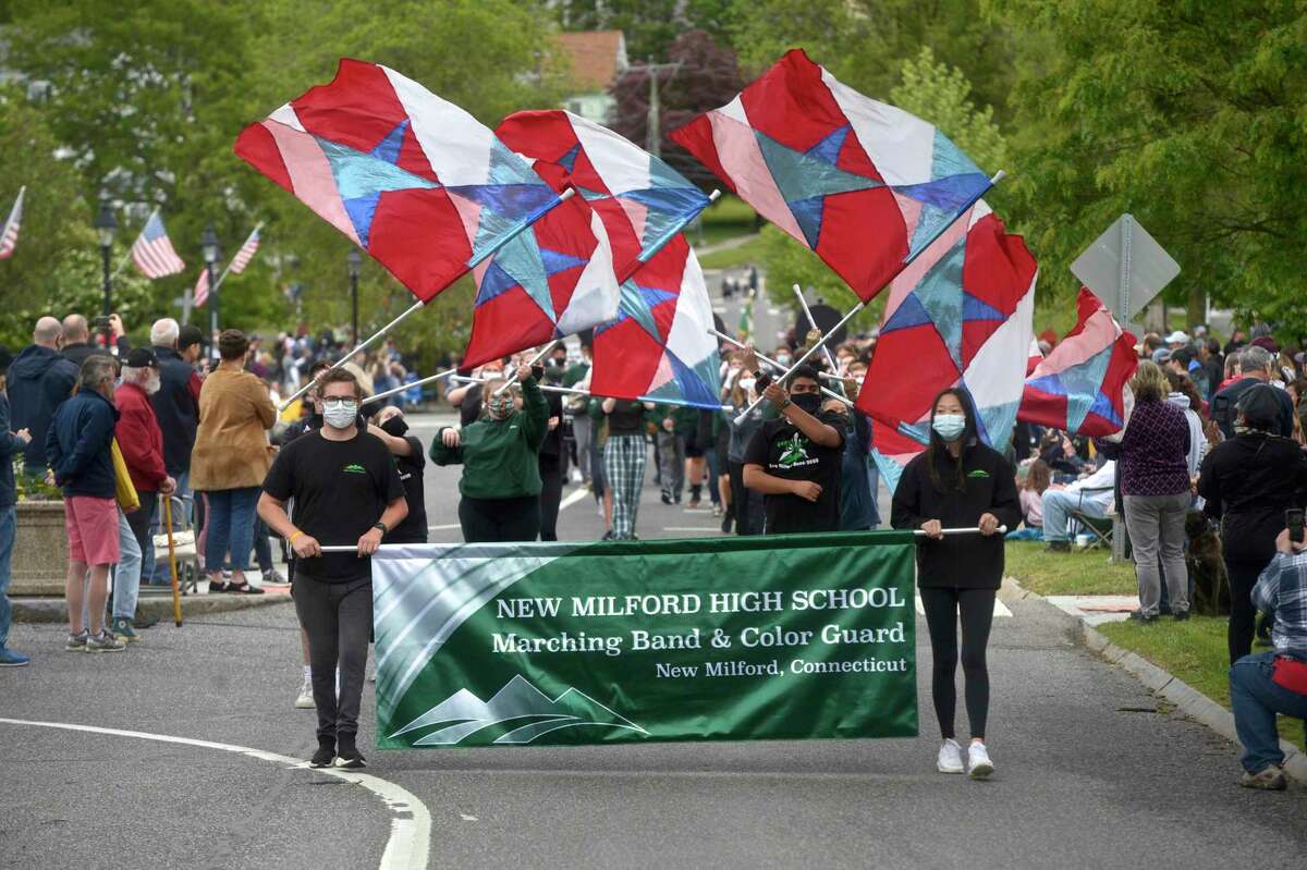 The New Milford High School Marching Band and Color Guard march in the Memorial Day parade in New Milford, Conn, Monday, May 31, 2021.