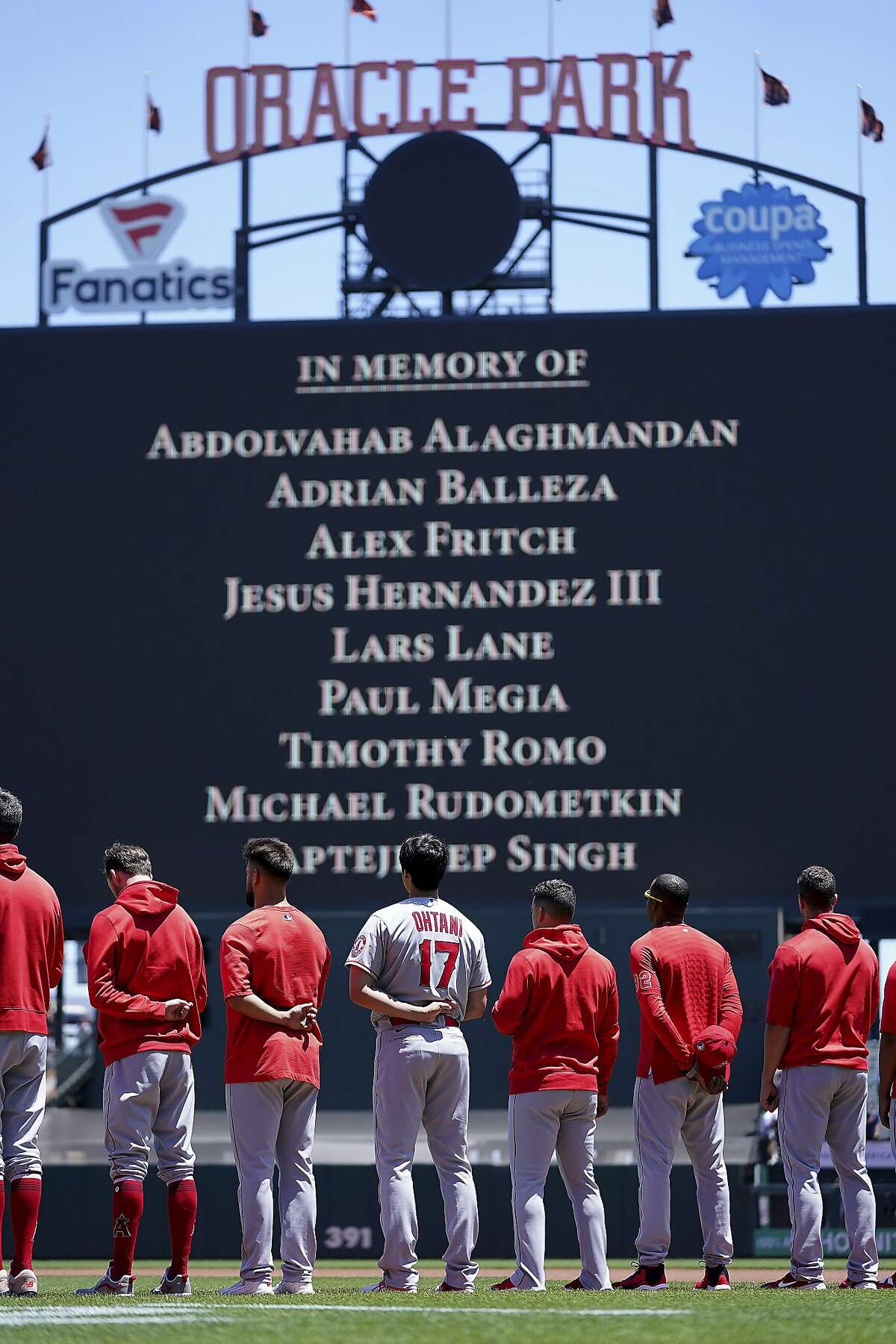 Players observe a moment of silence to honor the shooting victims from San Jose, Calif., before a baseball game between the San Francisco Giants and the Los Angeles Angels, Monday, May 31, 2021, in San Francisco. (AP Photo/Tony Avelar)