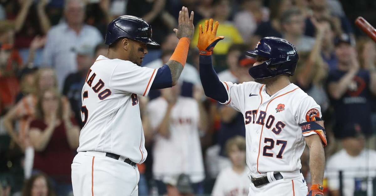 Houston Astros Jose Altuve (27) celebrates with Martin Maldonado (15) after hitting a two-run home run during the third inning of an MLB baseball game at Minute Maid Park, Monday, May 31, 2021, in Houston.