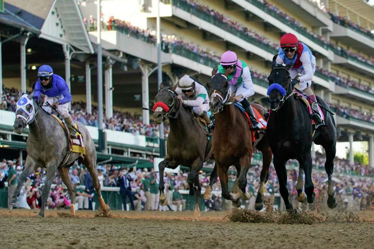 John Velazquez riding Medina Spirit, right, leads Florent Geroux on Mandaloun, Flavien Prat riding Hot Rod Charlie and Luis Saez on Essential Quality to win the 147th running of the Kentucky Derby at Churchill Downs, Saturday, May 1, 2021, in Louisville, Ky.