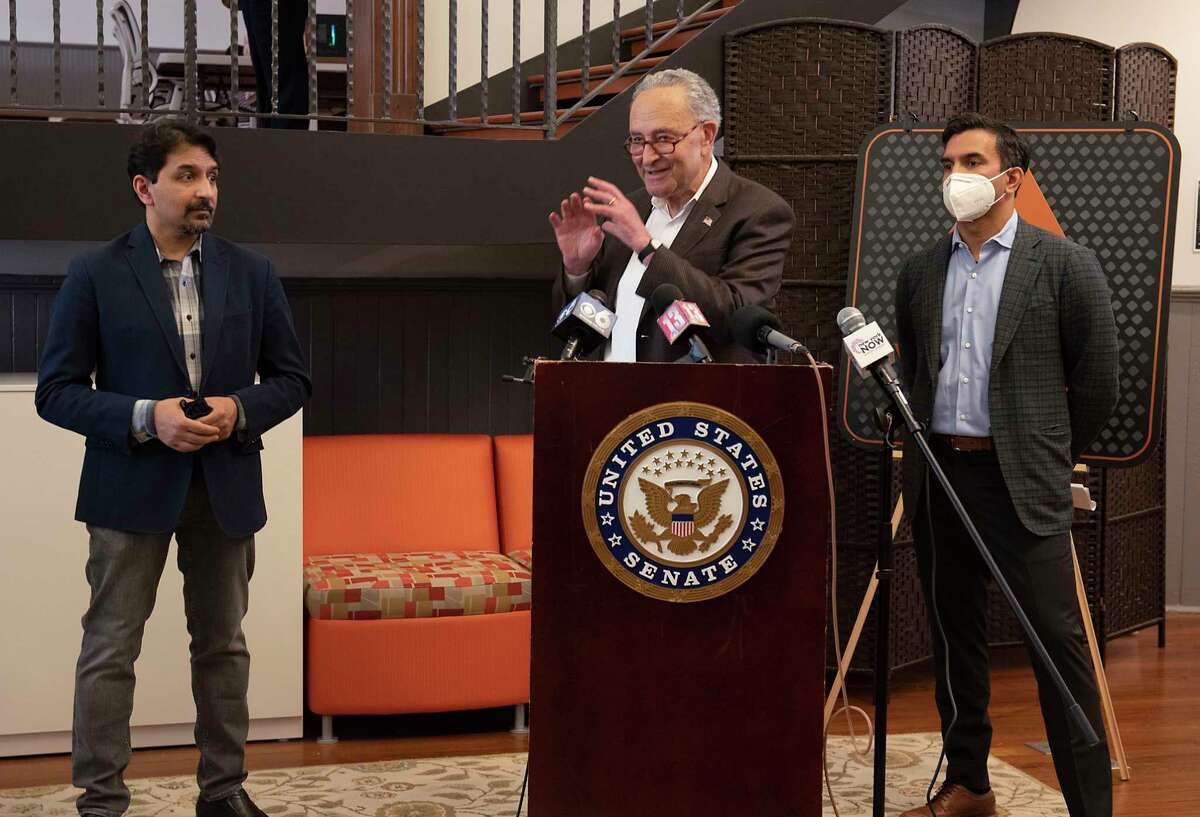 U.S. Senate Majority Leader Charles Schumer speaks to the media during a visit to Velan Studios on Tuesday, June 1, 2021 in Troy, N.Y. Co-founders Karthik, left, and Guha Bala stand next to Schumer. The Bala brothers launched the Capital Region's video game cluster decades ago and have been innovating with new video game technologies. (Lori Van Buren/Times Union)