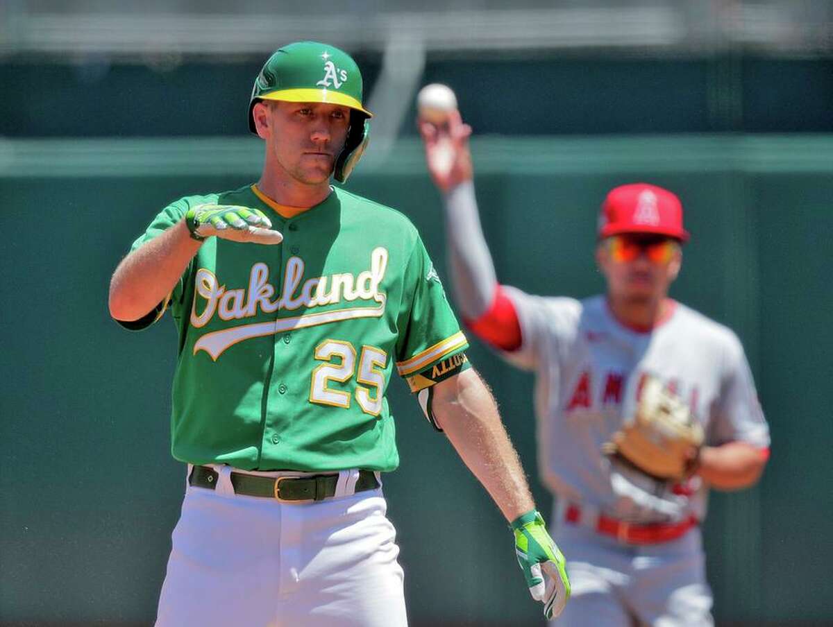 Stephen Piscotty (25) gestures to the clubhouse after hititng a double in the second inning as the Oakland Athletics played the Los Angeles Angels at the Coliseum in Oakland, Calif., on Sunday, May 30, 2021.