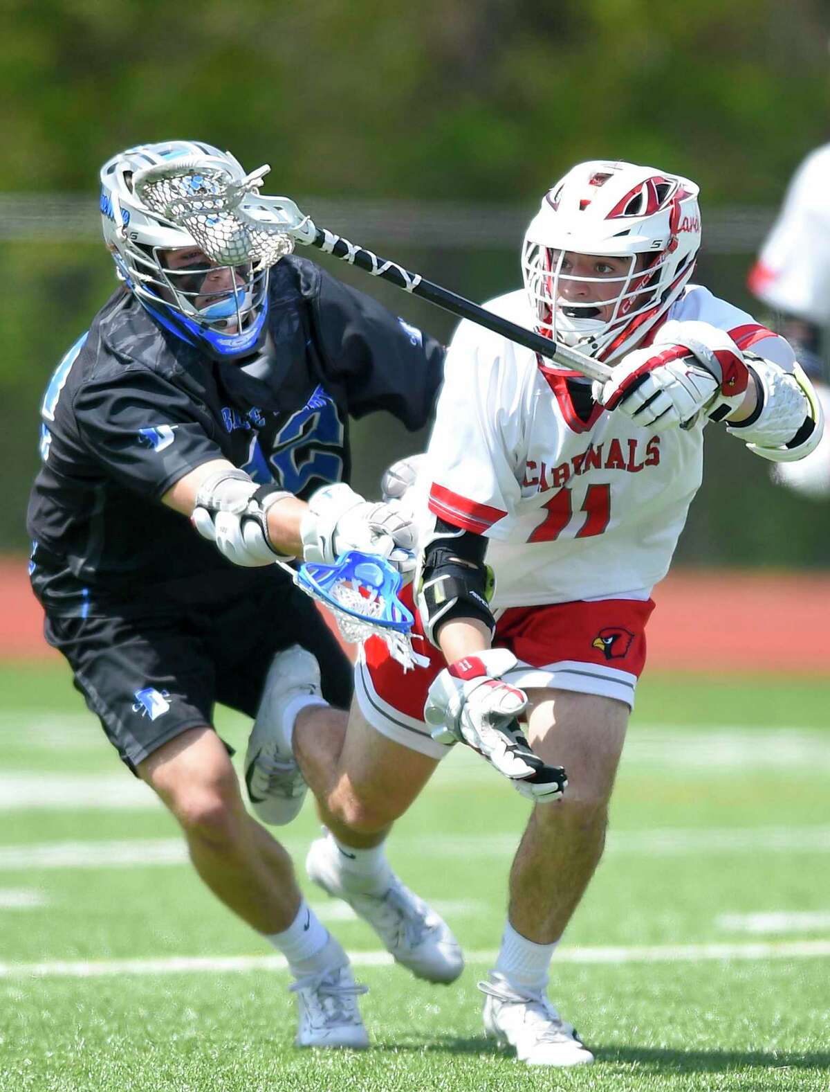 Darien's Bruce Ferguson (42) body checks Greenwich's Jack Cook (11) during a boys lacrosse match at Cardinal Stadium on May 4, 2019 in Greenwich, Connecticut. Darien defeated Greenwich 15-0.