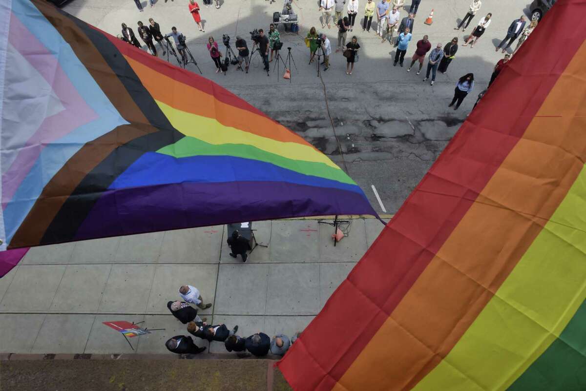 Pride flags fly outside Albany City Hall during the annual Pride Flag Raising event on Tuesday, June 1, 2021, in Albany, N.Y. The flag is stirring controversy in Milton and Ballston Spa. (Paul Buckowski/Times Union)