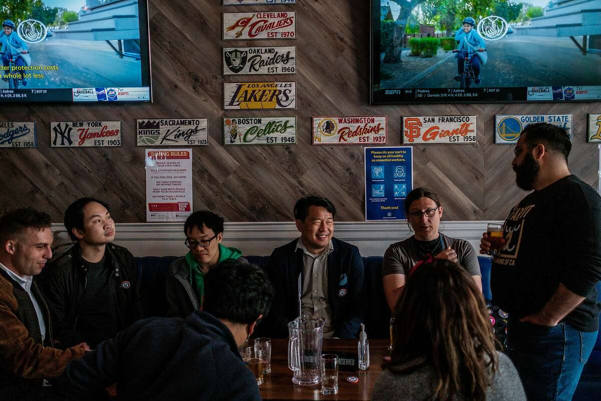 Brian Quan, center in a blue blazer, enjoys an evening out with his friends at Trademark & Copyright sportsbar in San Francisco on Saturday, May 29, 2021. Mr. Quan completed Mayor Breed’s “small business challenge” for the month of May by visiting a variety of small business in alphabetical order.