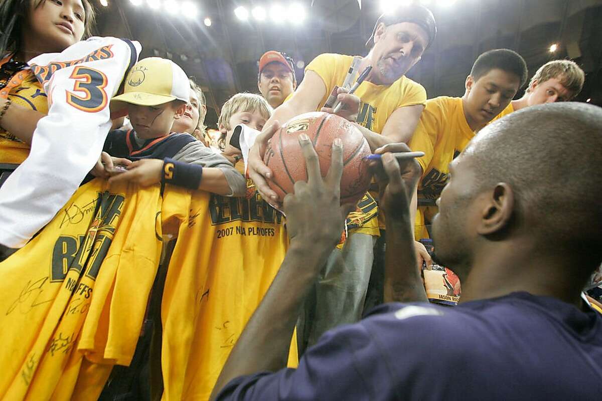 WARRIORS_GAME4_0119_KW.JPG Jason Richardson autographs a basketball for Mark Cooke from American Canyon after warming up prior to the game when Golden State Warriors play the Dallas Mavericks in playoff game #4 at Oracle Arena in Oakland on Friday April 29, 2007 . Kat Wade/The Chronicle