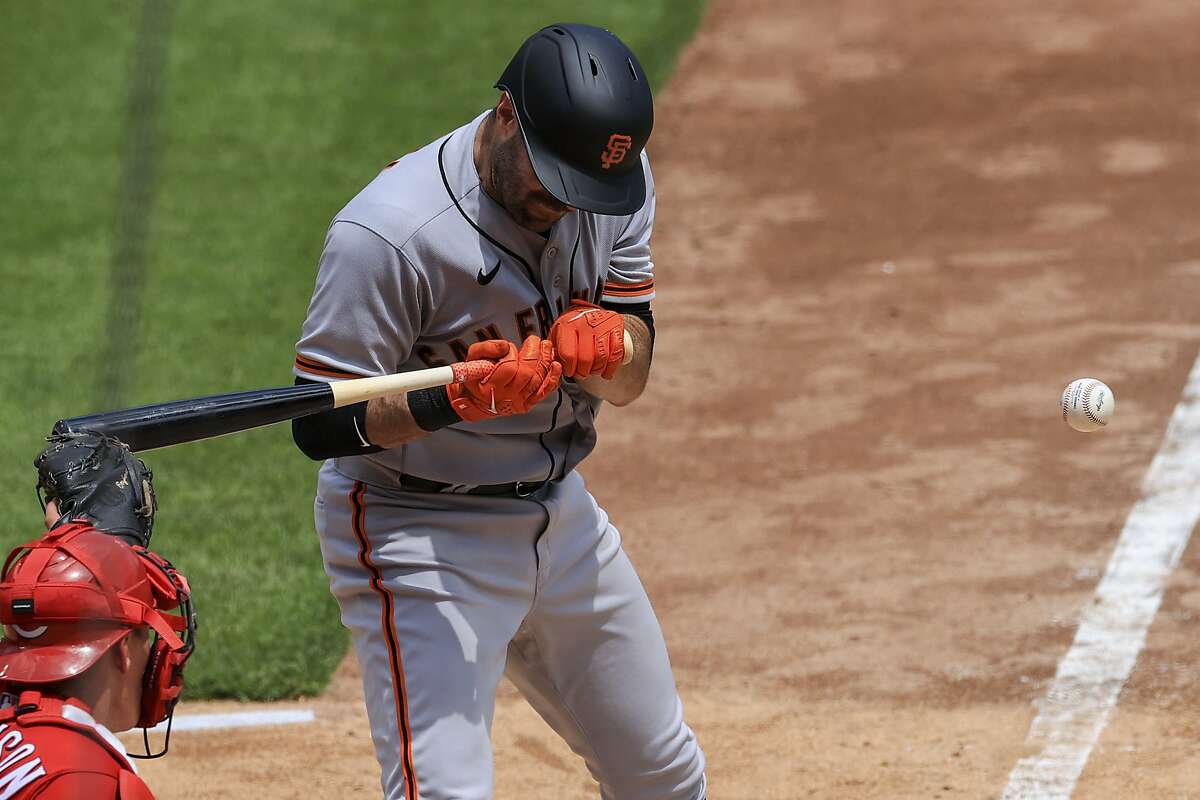 San Francisco Giants' Curt Casali reacts after being hit by a pitch during the fifth inning of a baseball game against the Cincinnati Reds in Cincinnati, Thursday, May 20, 2021. (AP Photo/Aaron Doster)