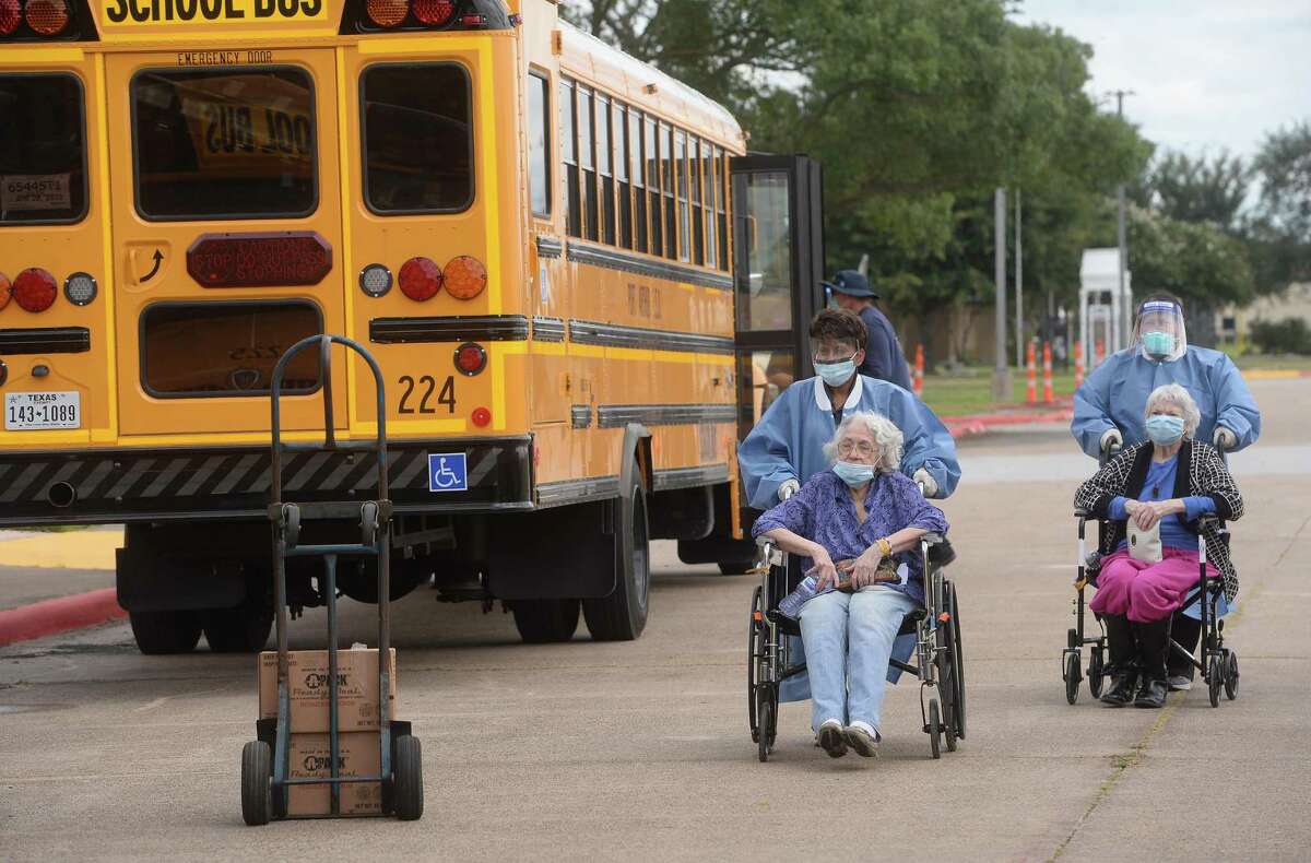 Medical personnel assist the elderly as they are put on a handicap accessible bus at the Bob Bowers Civic Center as evacuations begin Tuesday in Port Arthur. Photo taken Tuesday, August 54, 2020 Kim Brent/The Enterprise