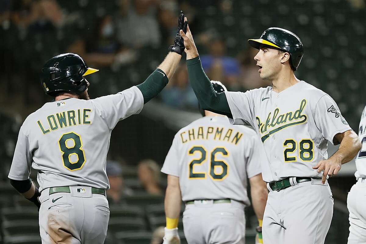 SEATTLE, WASHINGTON - JUNE 01: Jed Lowrie #8 and Matt Olson #28 of the Oakland Athletics celebrate a run against the Seattle Mariners during the seventh inning at T-Mobile Park on June 01, 2021 in Seattle, Washington. (Photo by Steph Chambers/Getty Images)