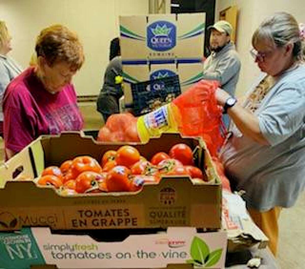 The Storehouse volunteers sort through food donations, including meat, produce and canned goods. A Friday opening is planned for the food pantry at 3420 College Ave., Alton.