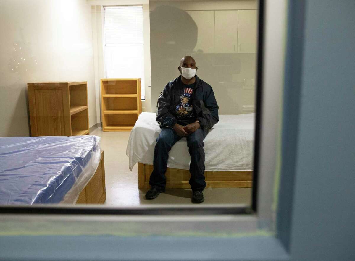 A patient at the Judge Ed Emmett Harris County Mental Health Diversion Center in Houston poses for a photograph in a room in December 2020. The center opened in fall 2018 as a way to connect mentally ill individuals to services rather than jail. As of Jan. 31, 2021, there have been about 3,500 diversions to the center.