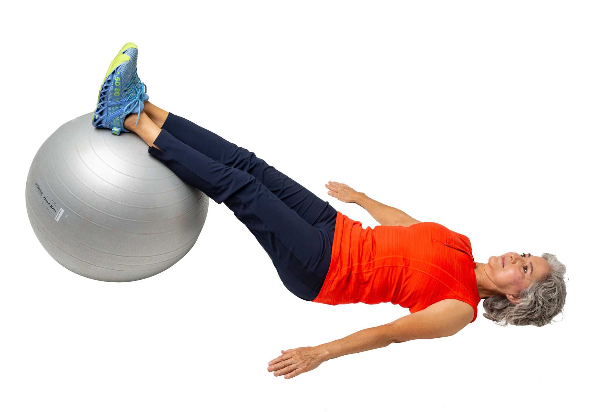 Lying supine stability ball bridge to hamstring curl