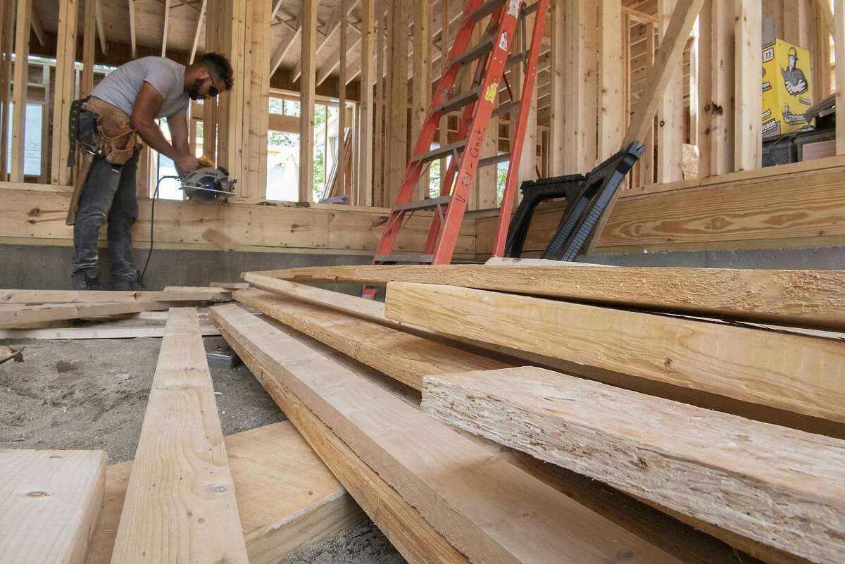 A construction worker is seen building a home in the Harmon Grove development on Wednesday, June 2, 2021 in Niskayuna, N.Y. This December prices are rising again after a drop from the summer.  (Lori Van Buren/Times Union file)