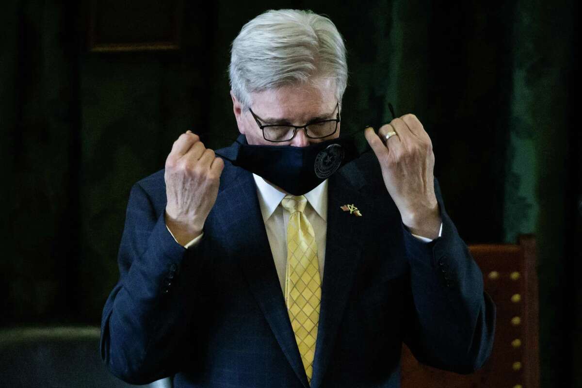 Texas Lt. Gov. Dan Patrick takes his mask off before he presides over the State Senate on the second day of the 87th Texas legislature on Wednesday, Jan. 13, 2021 at the Texas state Capitol, in Austin, Texas. (Lynda M. González/The Dallas Morning News)