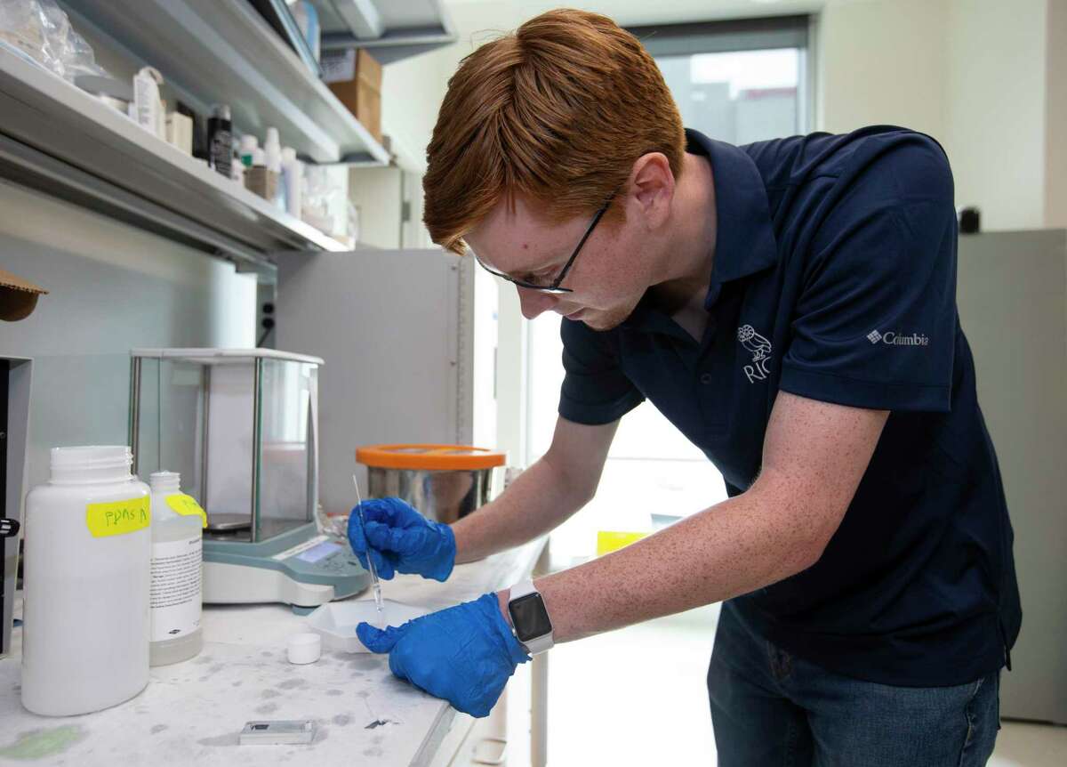 Rice University electrical and computer engineering graduate student Matthew Parker mixes chemicals together to make a polymer that holds a circuit Friday, May 21, 2021, in Houston.