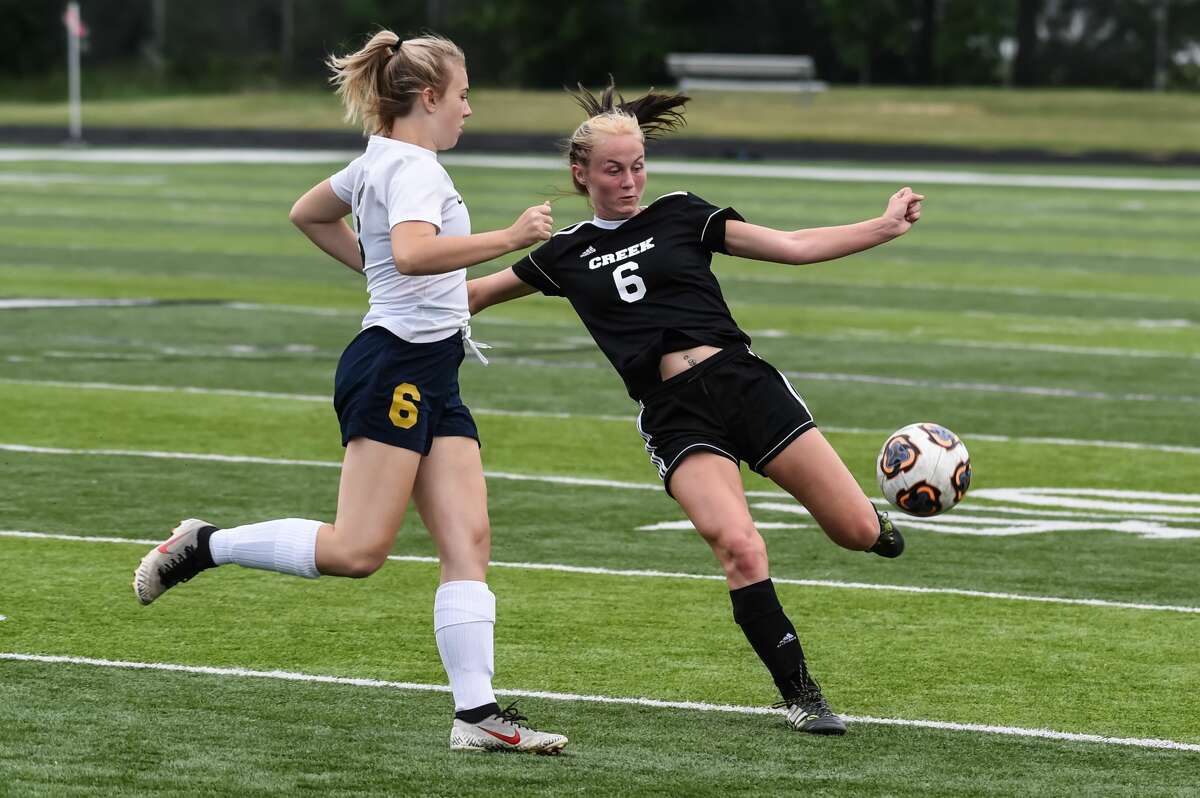 Bullock Creek's Lydia Bertrand moves the ball up field during the Lancers' game against Ovid-Elsie Wednesday, June 2, 2021 at Freeland High School. (Adam Ferman/for the Daily News)