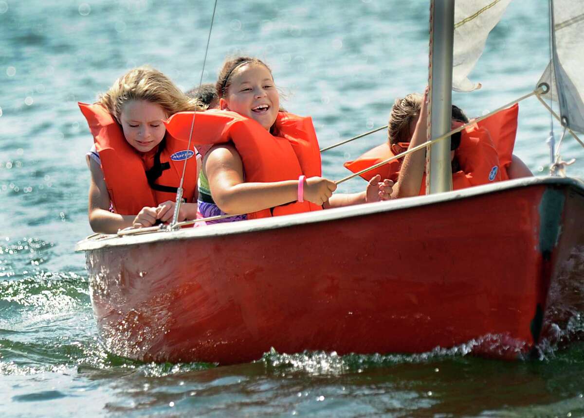 Katherine Donato, 8, left, of New Fairfield, and Skye Parsell, 9, of Bethel go for a sail with their campmates at the Candlewood Day Camp in New Fairfield Friday, July 10. Sailing lessons is one of the activities available at this Girl Scout camp located on Candlewood Lake.