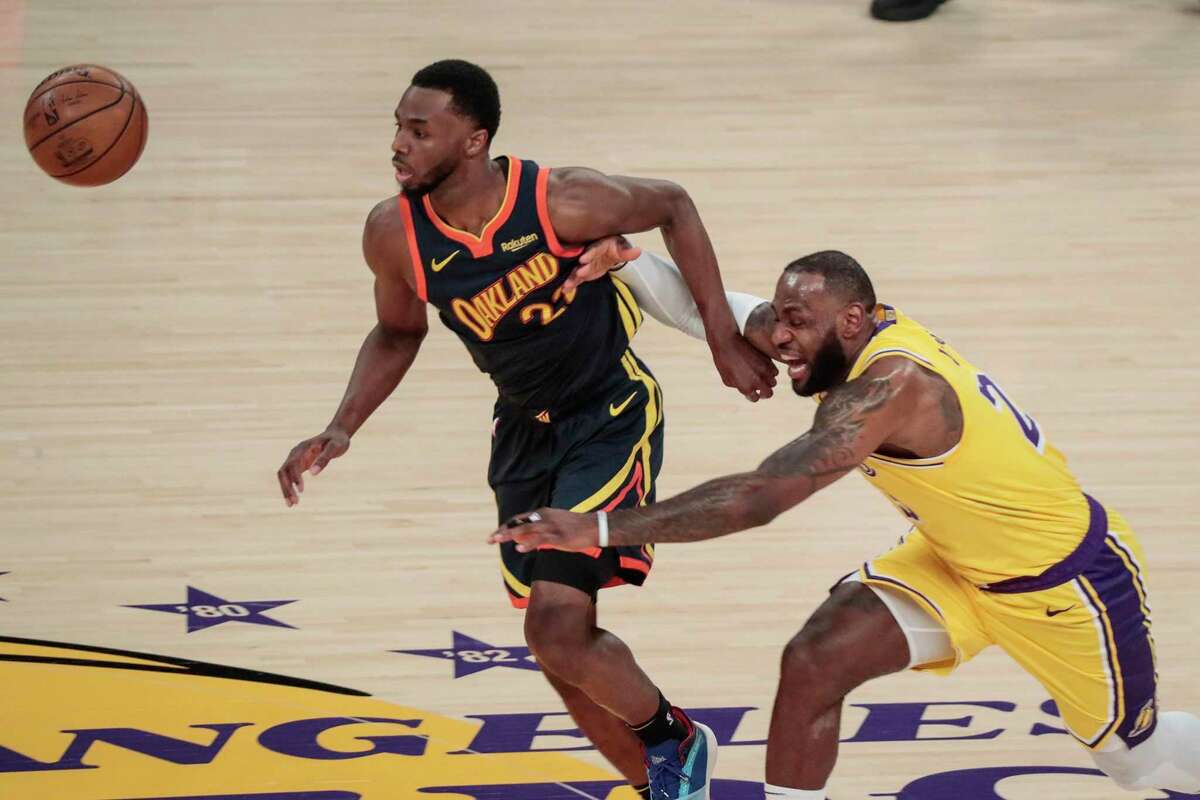 The Los Angeles Lakers' LeBron James, right, knocks the ball away from the Golden State Warriors' Andrew Wiggins during first-half action in a play-in playoff game at Staples Center in Los Angeles on Wednesday, May 19, 2021. (Robert Gauthier/Los Angeles Times/TNS)