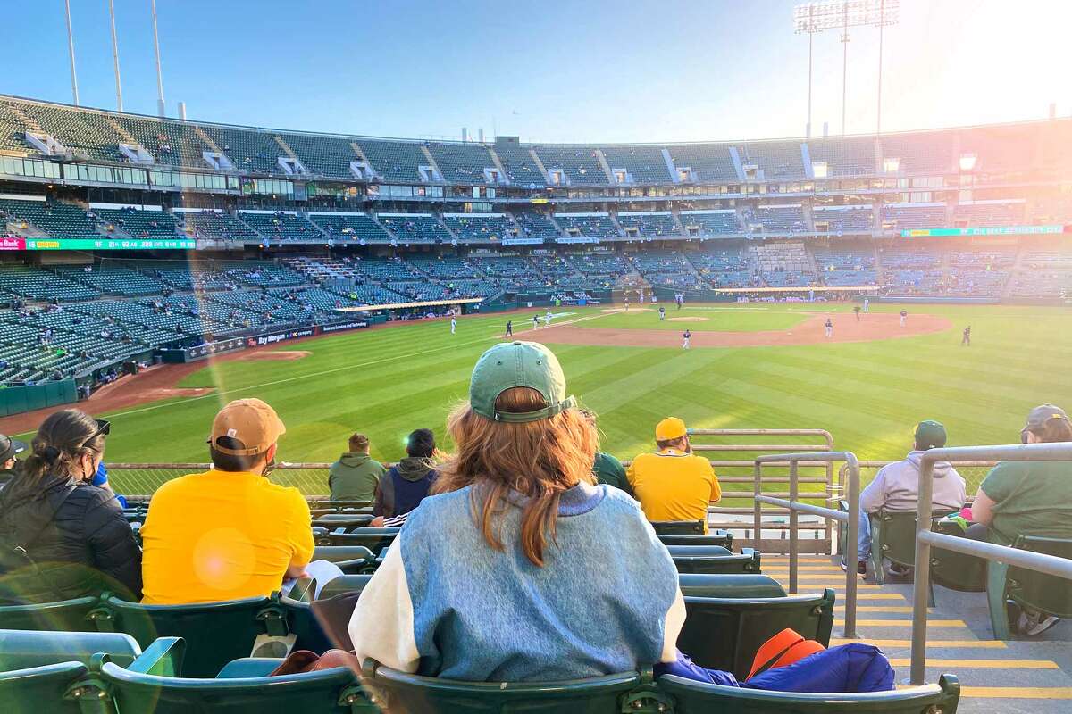 SFGATE reporter Madeline Wells watches the Oakland Athletics play against the Seattle Mariners in RingCentral Coliseum on May 25, 2021 in Oakland, Calif.