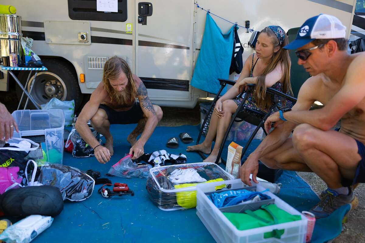 Ultrarunner Timothy Olson, left, at camp with his wife, Krista, and trainer Jason Koop on his hike on the Pacific Crest Trail.