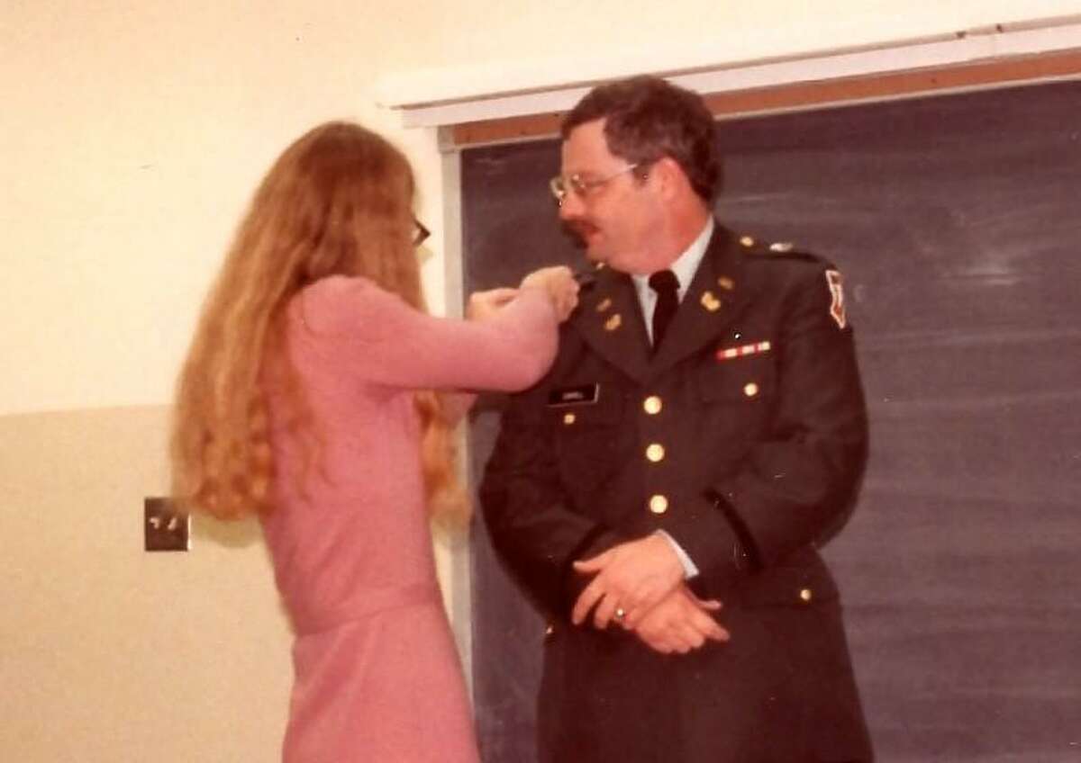 Joleen Cahill pins a lapel on Michael Cahill during a ceremony designating him as a U.S. Army Chief Warrant Officer 2 in 1985.