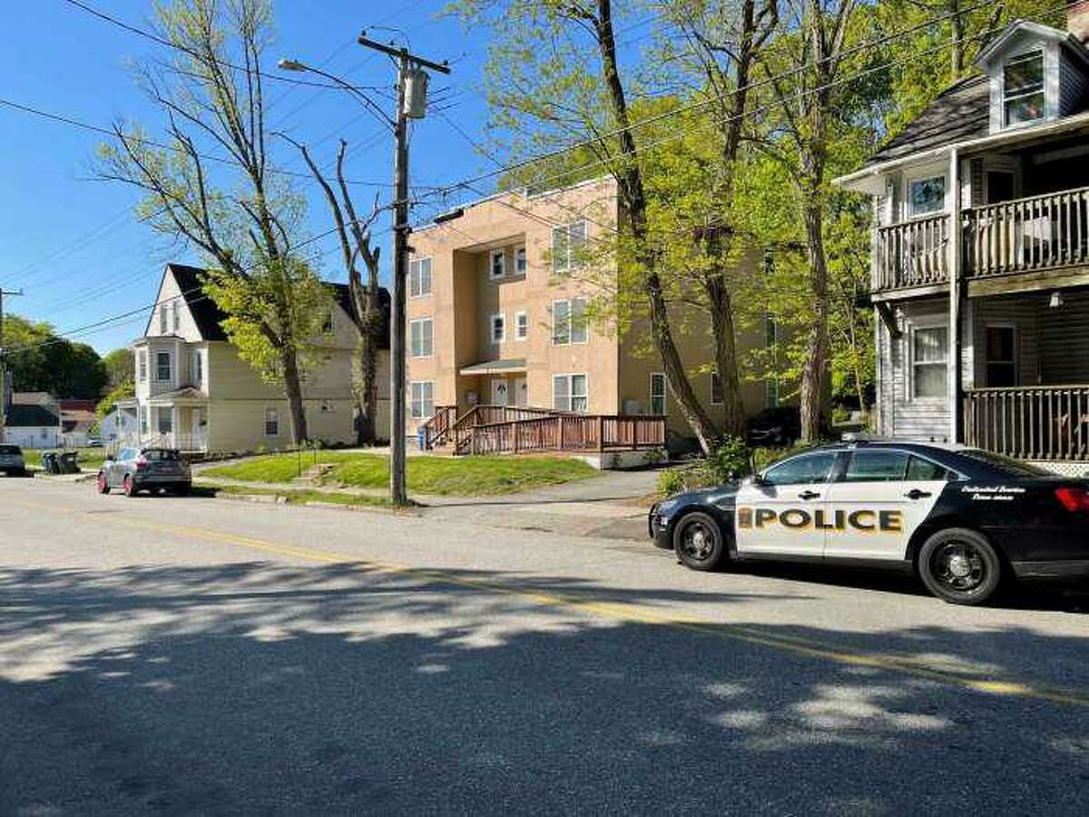 A police cruiser seen on McKinley Avenue in Norwich, Conn., on May 11, 2021, after a 1-month-old boy was killed Monday night after being attacked by the family dog inside an apartment (center).