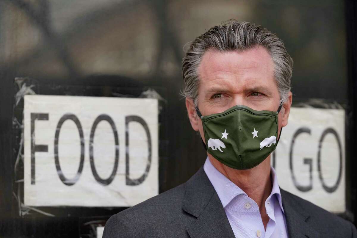 California Gov. Gavin Newsom waits to speak at a news conference about relief for restaurants outside Tommy's Mexican Restaurant in San Francisco, on Thursday, June 3, 2021. 