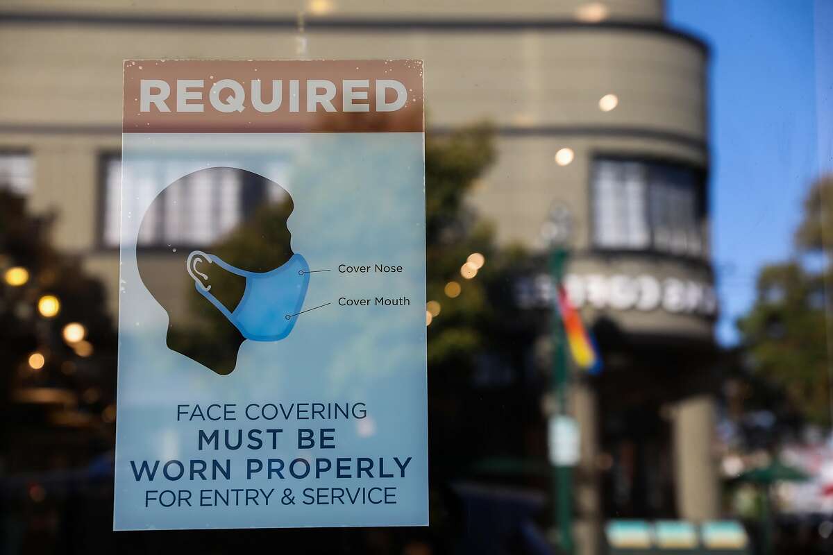 A poster detailing mask instructions is displayed at a business on Park St. on Thursday, June 3, 2021, in Alameda, Calif.