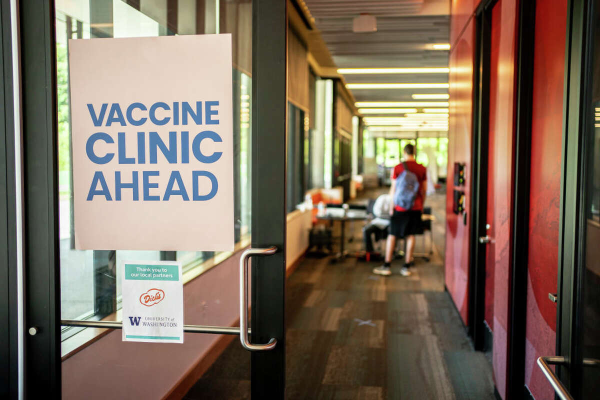 A sign directs patients at a COVID-19 vaccination clinic on the University of Washington campus on May 18, 2021 in Seattle, Washington. The two-day clinic, in partnership with Safeway, Dicks Drive-In Restaurants, and the Seattle Metropolitan Chamber of Commerce, is offering newly-vaccinated patients a free Dicks burger when they leave. 