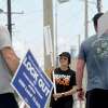 ExxonMobil hourly workers with the United Steel Workers Union, including (from left) Craig Price, Gina Vila and Trey Peters, continue their 4-hour picket shift outside the Beaumont plant Monday, May 10. Photo made Monday, May 10, 2021 Kim Brent/The Enterprise