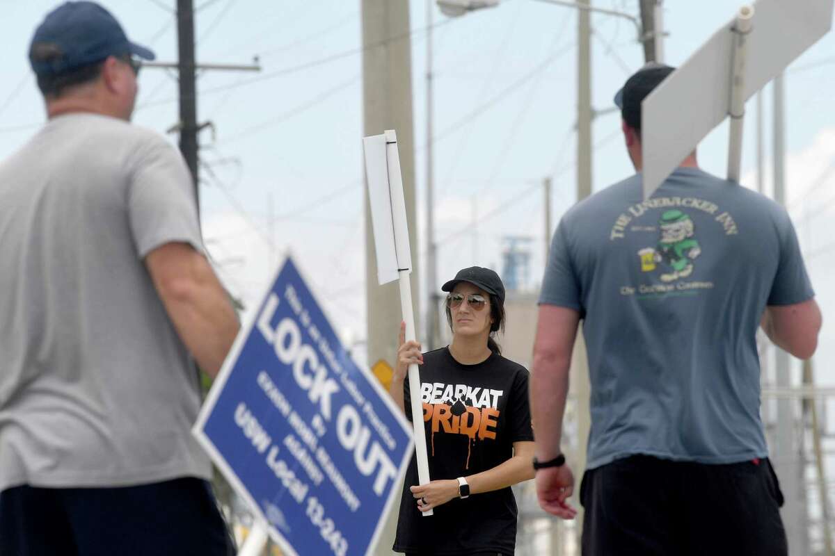 ExxonMobil hourly workers with the United Steel Workers Union, including (from left) Craig Price, Gina Vila and Trey Peters, continue their 4-hour picket shift outside the Beaumont plant Monday, May 10. Photo made Monday, May 10, 2021 Kim Brent/The Enterprise