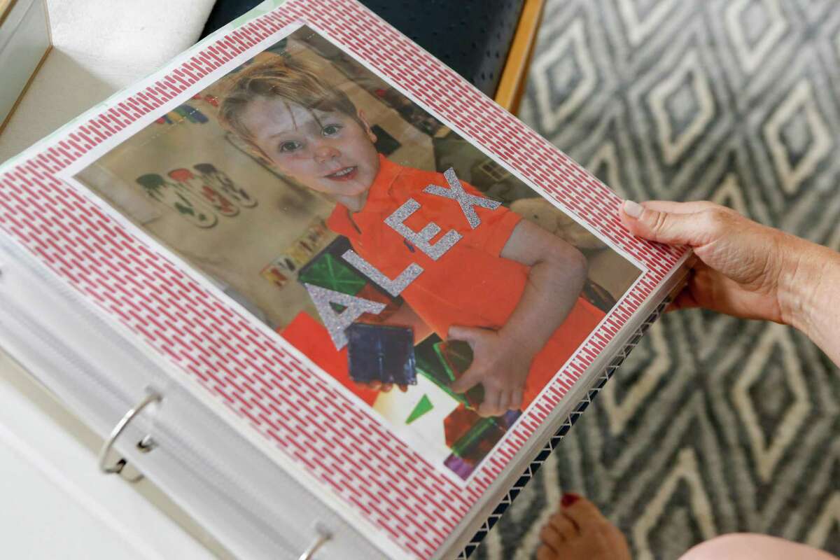 Dayna Quanbeck goes through a photo album of her son Alex in their home on Friday, June 4, 2021 in San Francisco, Calif.
