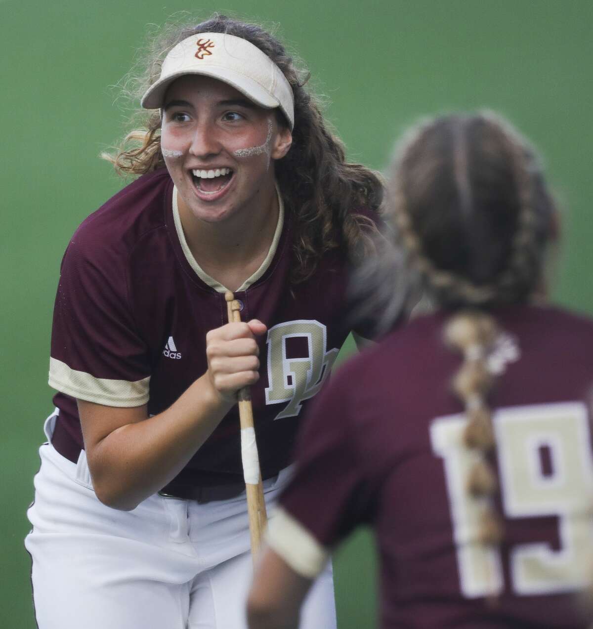 Lindsey McKnight #10 of Deer Park sings into a drumstick during a break in the third inning of a Class 6A state semifinal game, Friday, June 4, 2021, in Leander.