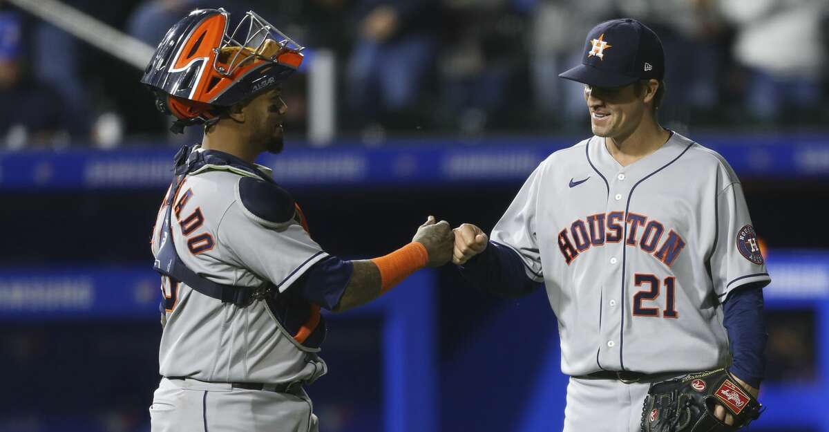 Houston Astros catcher Martin Maldonado (15) and starting pitcher Zack Greinke (21) celebrate after the last out of a baseball game against the Toronto Blue Jays in Buffalo, N.Y., Friday, June 4, 2021. (AP Photo/Joshua Bessex)