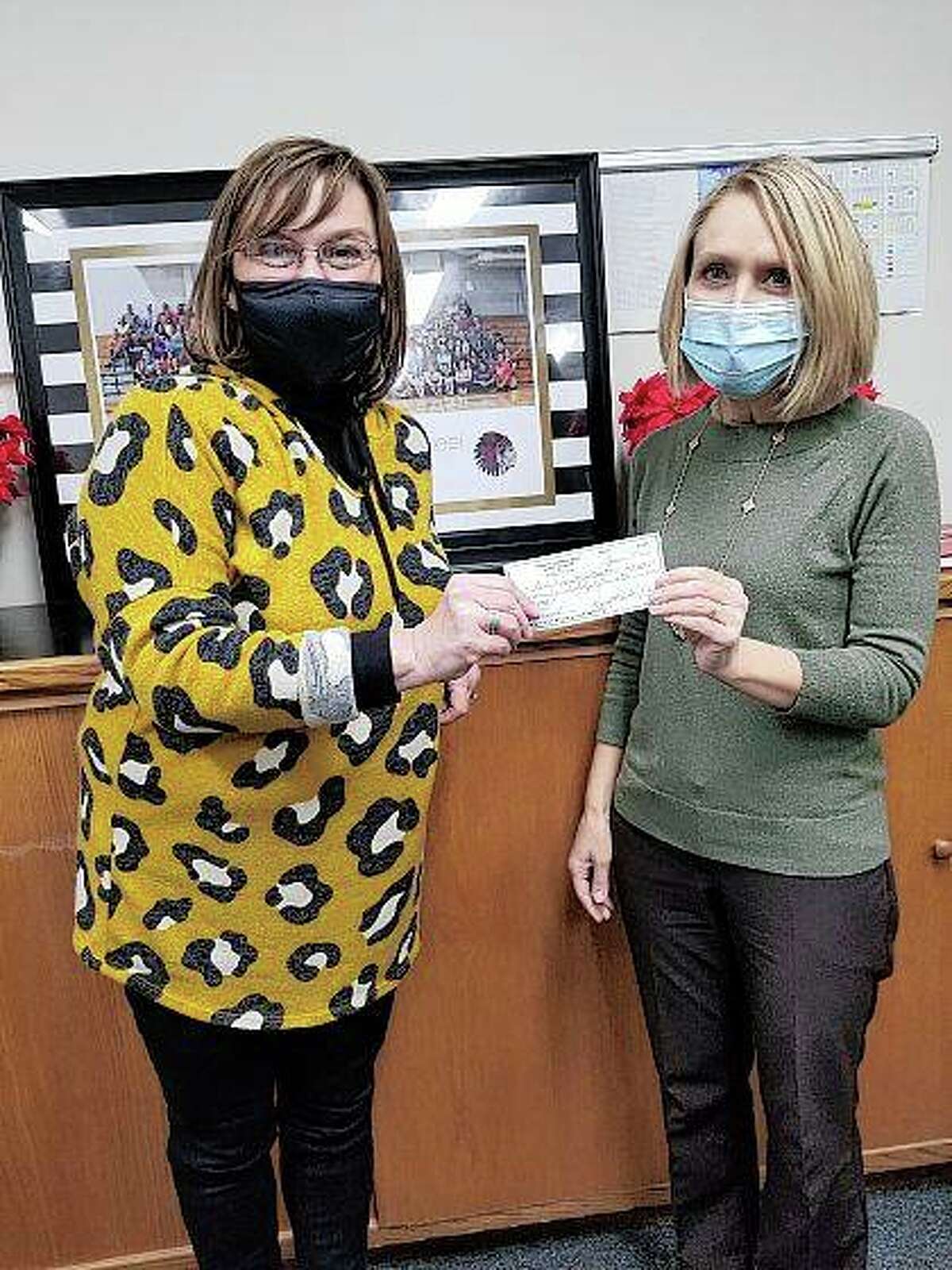 Rotary Club of Pike County President Sheila Davidsmeyer (right) presents a check to Pikeland schools Superintendent Carol Kilver. The money helped fund the district’s personal protective equipment purchases amid the COVID-19 pandemic.