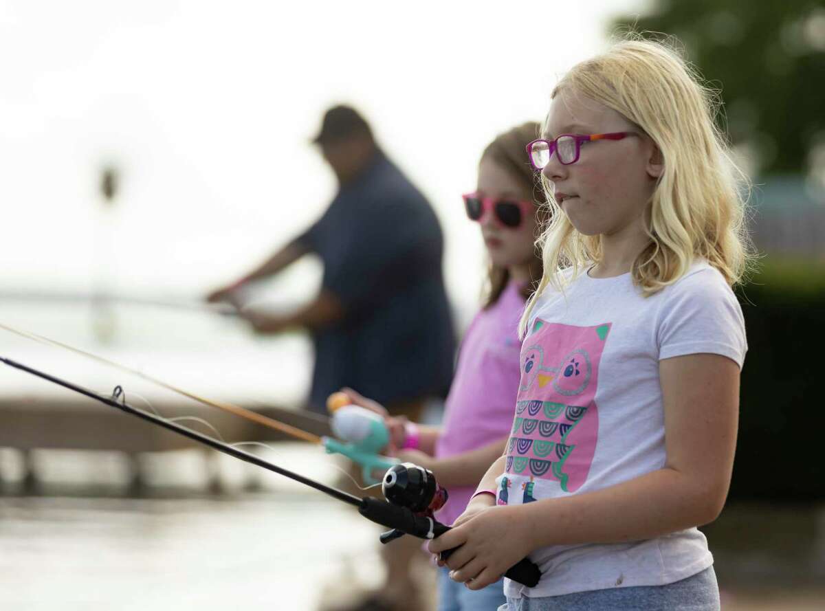 Taylor Newton holds a fishing rod June 5 during Kids Fish Fest at the Safe Harbor Walden Marina in Montgomery.
