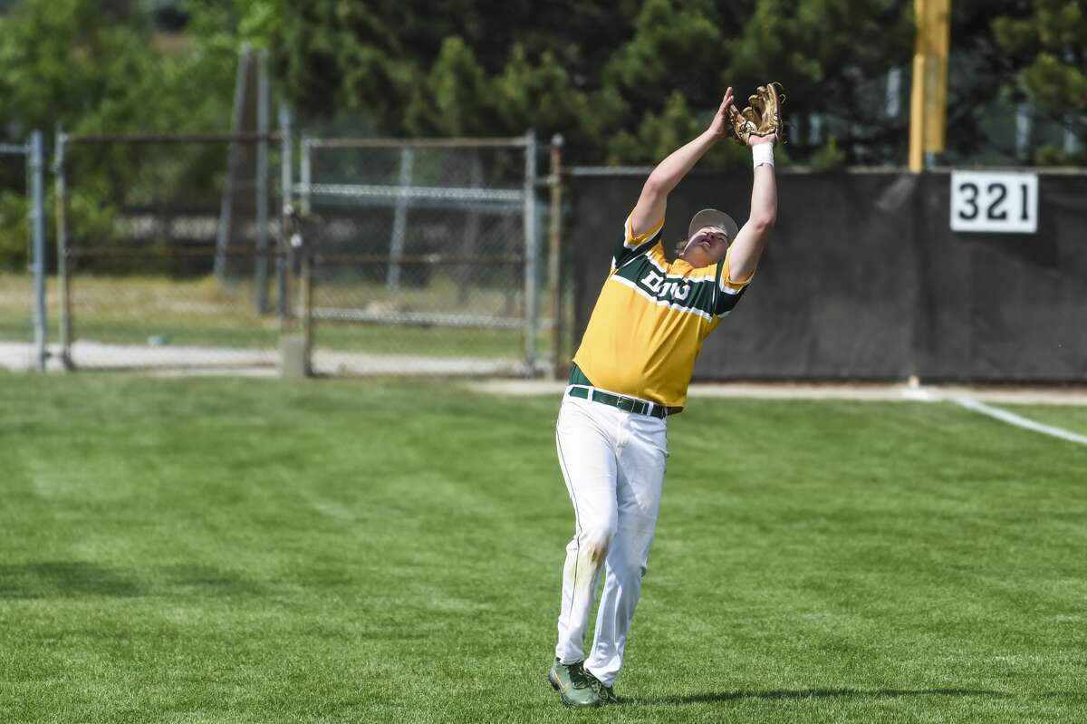 Dow's Jack Bakus catches a fly ball during the Chargers' district final against Bay City Western Saturday, June 5, 2021 at Western. (Adam Ferman/for the Daily News)