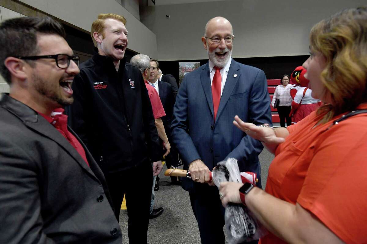 Dr. Ken Evans, President of Lamar University, jokes with (from left) Aron Arceneaux, John Ellis and Mandy Arceneaux during a goodbye party held in his honor Friday at the McDonald Gym. Evans served the campus and community for 8 years, and will leave to take a new position in Oklahoma starting in July. Photo made Friday, June 4, 2021 Kim Brent/The Enterprise