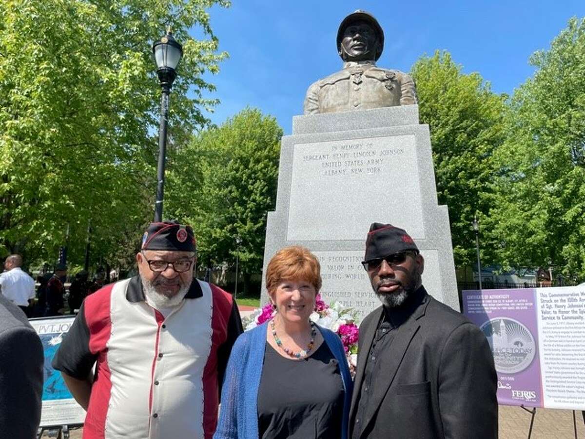 369th Regiment veterans pose by one of the two statues of Henry Johnson in Albany. From left to right: veteran Jim Dandles, Mayor Cathy Sheehan and veteran Ronald Wilson, president of the Albany District of the 369th Veterans Association.