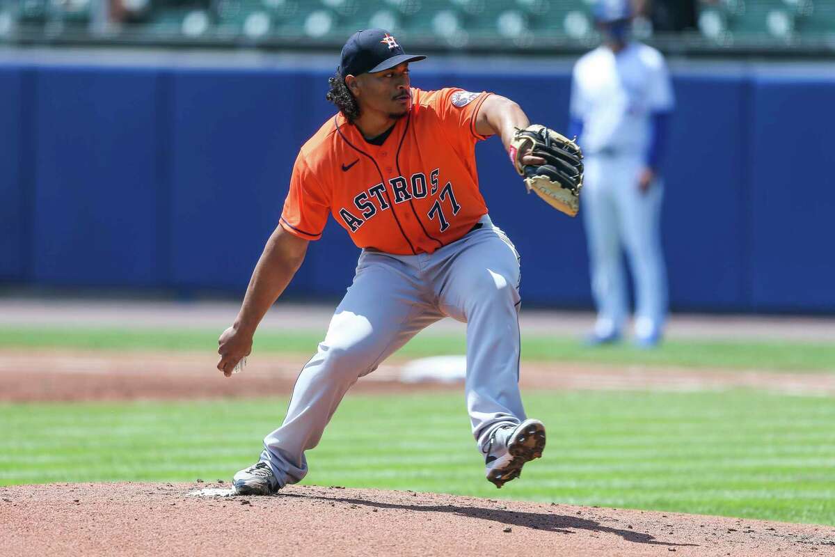 Houston Astros starting pitcher Luis Garcia (77) throws during the