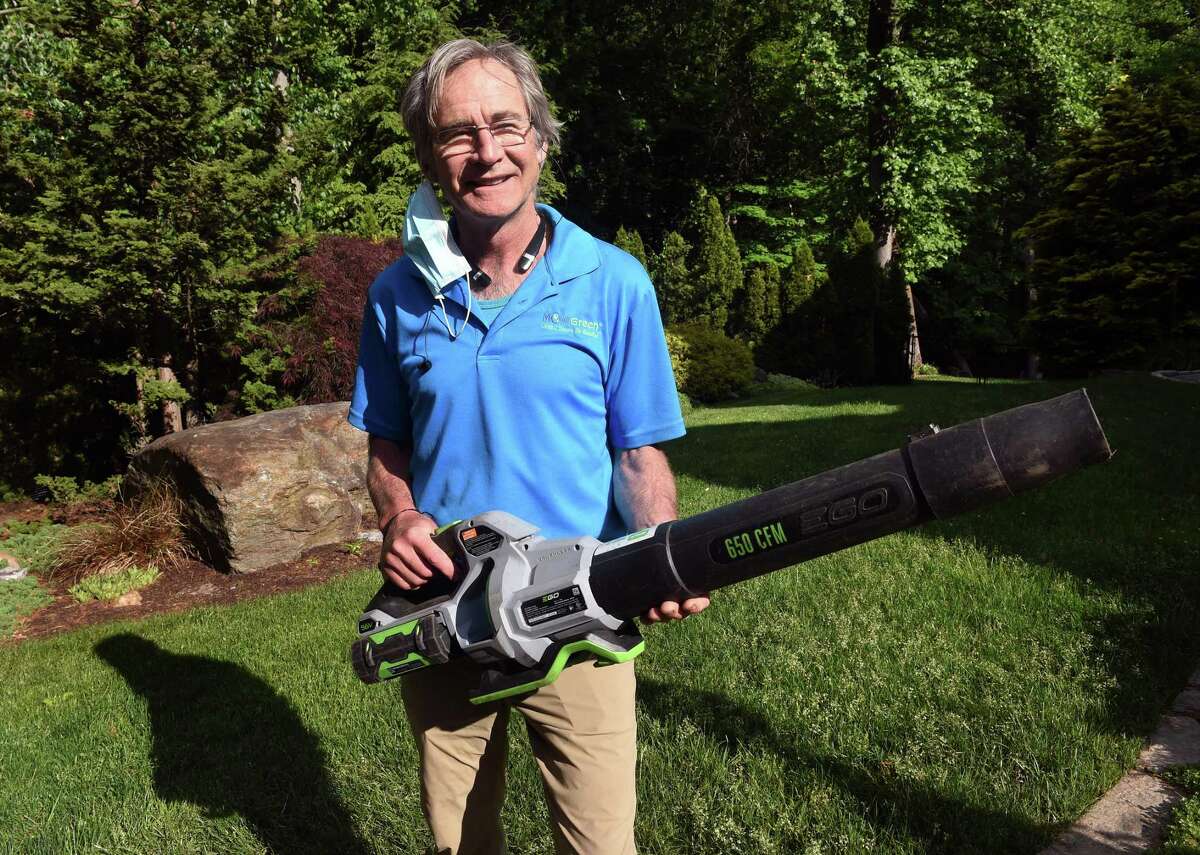 Dan Delvanthal, owner of Mow Green Organic Lawn Care, holds one of the battery powered leaf blowers his company uses in Fairfield on May 28, 2021.