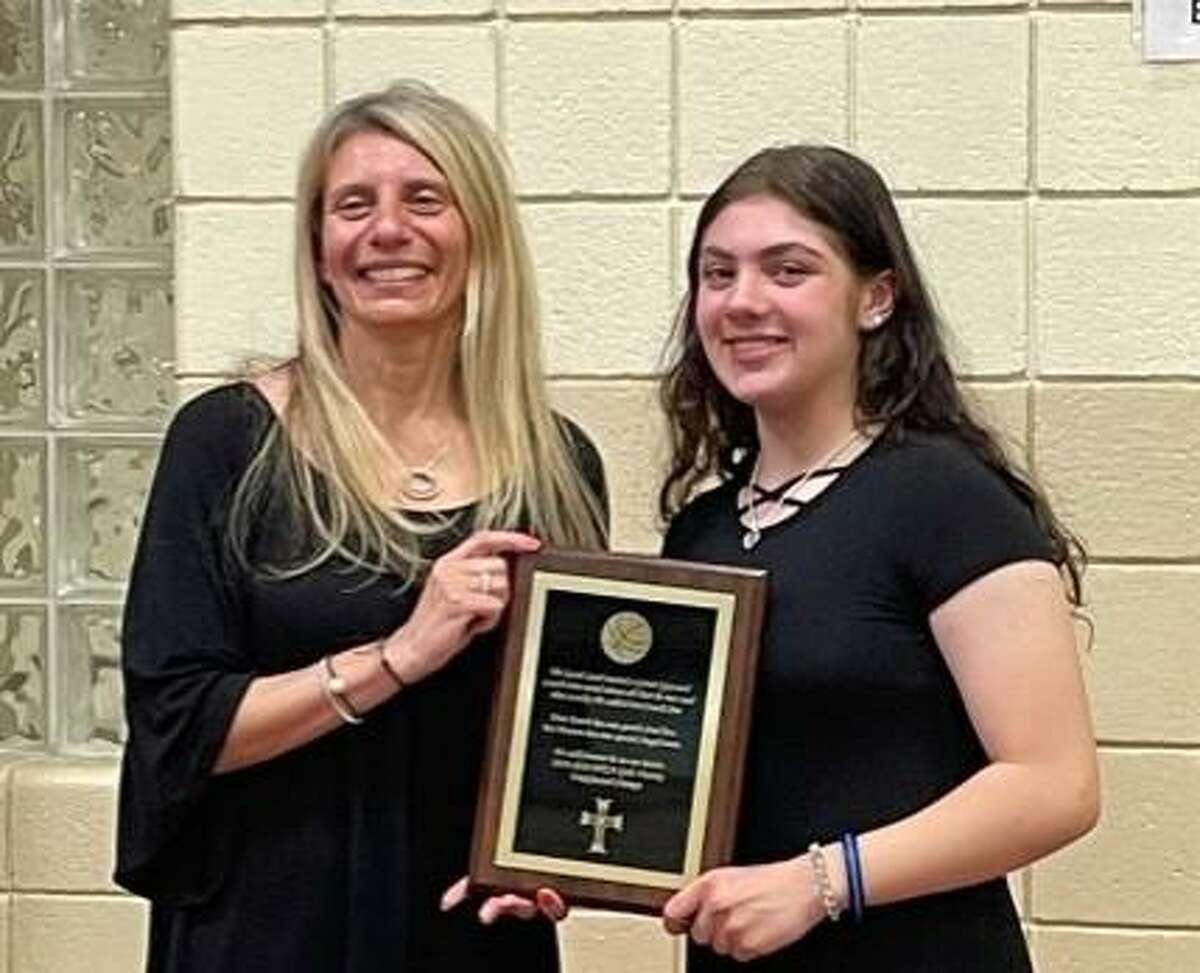 The Holy Trinity Catholic Academy recently celebrated the girls basketball team that finished an unbeaten regular season in 2019-20. The event also honored Jim McKenna, who coached the team and died on Jan. 1, 2021. Among those who spoke were McKenna's daughter, Angelina. Pictured are Angelina, right, and her mother, Gina McKay.
